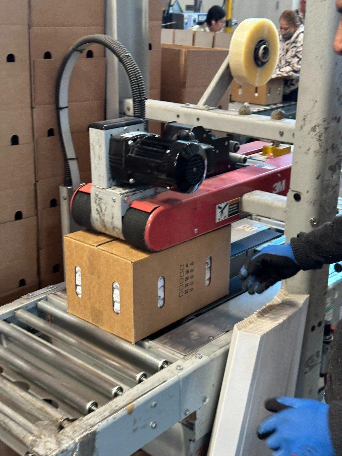 Production line packaging medical-grade shipping cartons